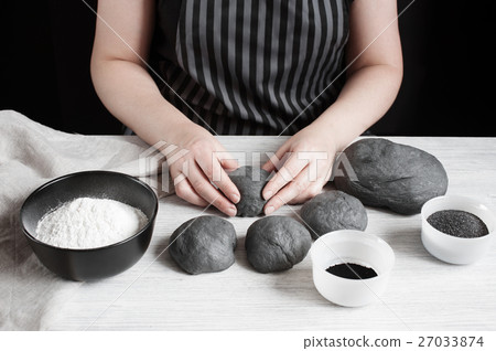 Female hands form the black buns 27033874