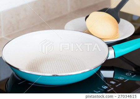 Making home made pancakes on frying pan 27034615