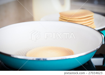 Making home made pancakes on frying pan 27034623