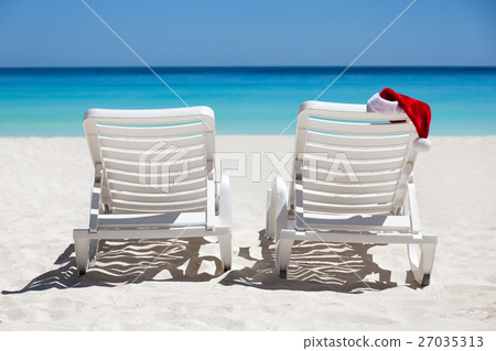 Santa Claus Hat on sunbed at beach 27035313