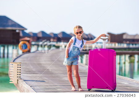 Little adorable girl with big luggage near water Little adorable girl with big luggage near water 27036043
