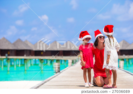 Young mother and little girls in Santa hat on Young mother and little girls in Santa hat on 27036089