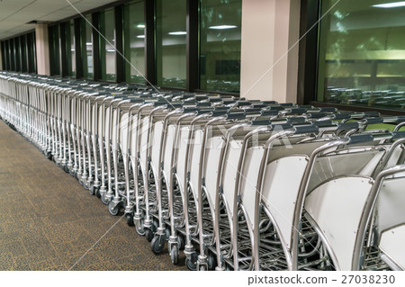 luggage carts at airport terminal . 27038230