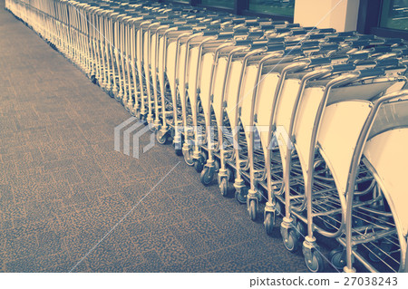 luggage carts at airport terminal . ( Filtered image processed vintage effect. ) 27038243