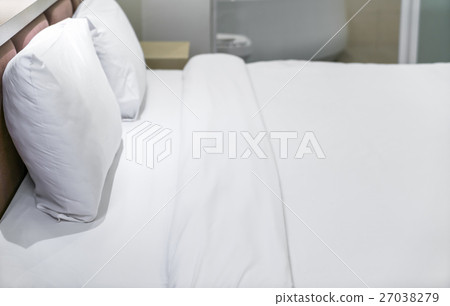 Comfortable pillows and bed . 27038279