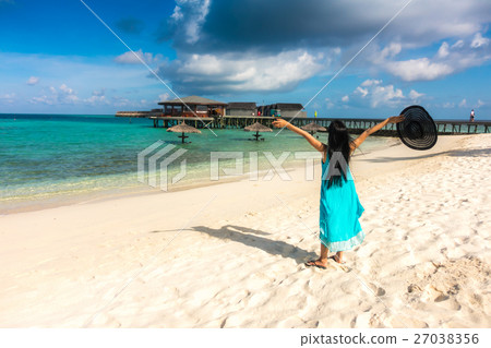 Portrait of happy young woman at beautiful water villa at Maldives island. Travel and Vacation. Outdoor shot. Portrait of happy young woman at beautiful water villa at Maldives island. Travel and Vacation. Outdoor shot. 27038356
