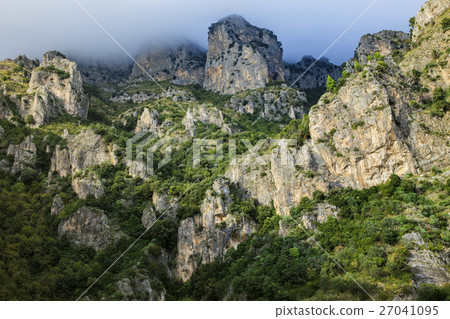 rock mountain and foggy clouds 27041095