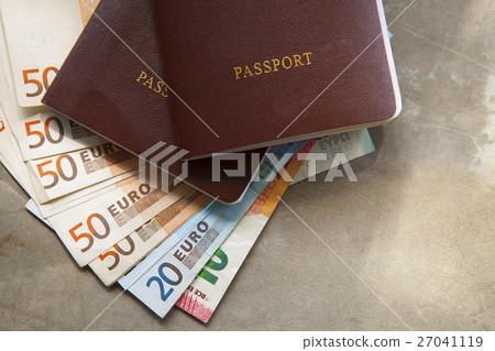 red passport book cover and euro banknote 27041119