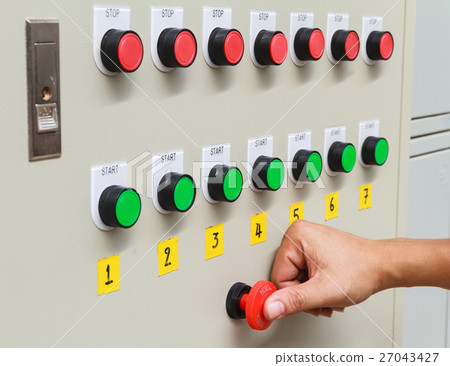Thumb touch on red emergency stop switch button. 27043427