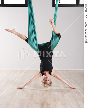 Stock Photo: Single upside down woman doing aerial yoga