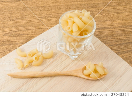 Elbow Macaroni or Gomiti Pasta on Cutting Board 27048234