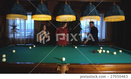 man plays Billiards and two young beautiful women man plays Billiards and two young beautiful women 27050463