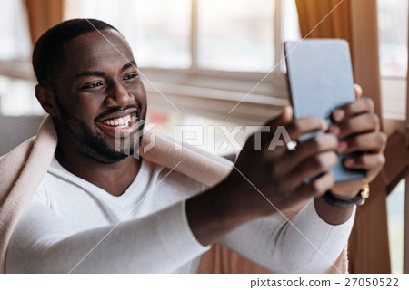Happy African American man communicate using the Happy African American man communicate using the 27050522
