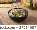 Green pumpkin seeds peeled in a black cup 27054097