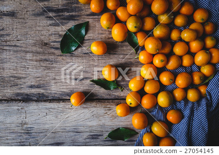 Fresh Kumquats on the old wood Fresh Kumquats on the old wood 27054145