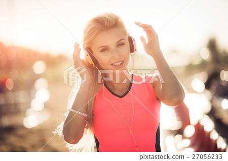 Young woman in sport wear enjoys and smiles 27056233