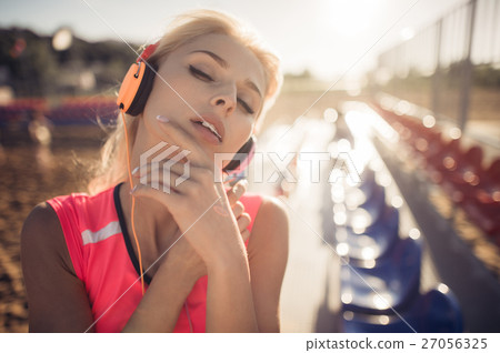 Young beautiful woman with headphones posing over Young beautiful woman with headphones posing over 27056325