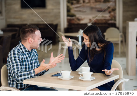 Young couple arguing in a cafe. She's had enough Young couple arguing in a cafe. She's had enough 27056970