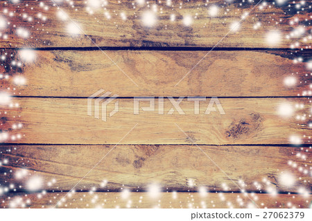 Above snow on wood board background and texture 27062379