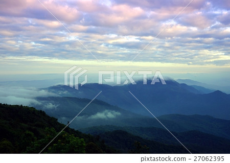 Mountain landscape with wave of fog and cloudy sky Mountain landscape with wave of fog and cloudy sky 27062395