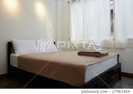 white king size bed, two pillows and towel  27062464