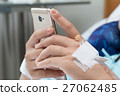 Female Patient Using Mobile Phone In Hospital Bed 27062485