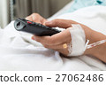 Female Patient watching TV and remote control 27062486