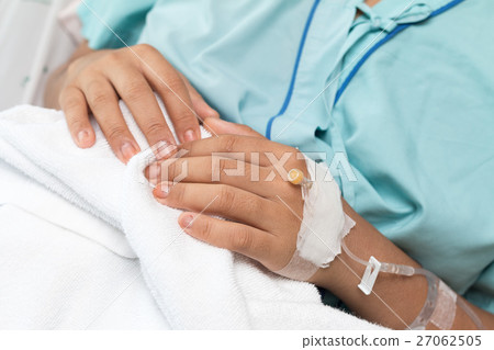 Focus on the hand of a patient in hospital ward 27062505