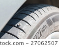 Screw nail puncturing tire. Close up. 27062507