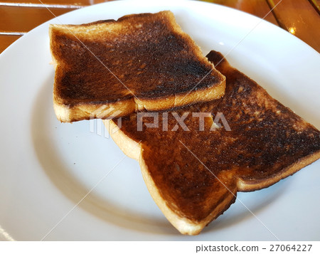 Burnt toast bread on white dish 27064227