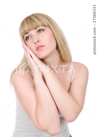 beautiful blonde with hands on a cheek looks aside 27066331