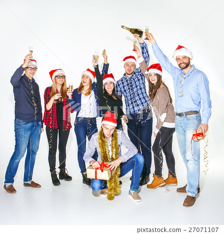 Many young women and men drinking at christmas Many young women and men drinking at christmas 27071107