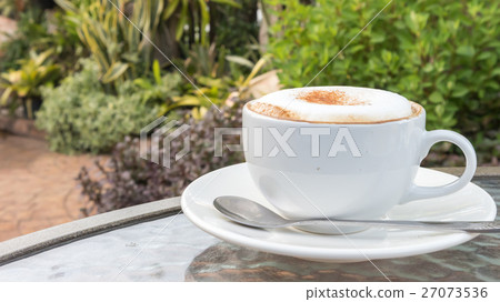 Closeup A cup of hot cappuccino on glass table Closeup A cup of hot cappuccino on glass table 27073536