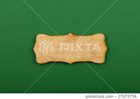 Figured shaped wooden sign on green background Figured shaped wooden sign on green background 27073736