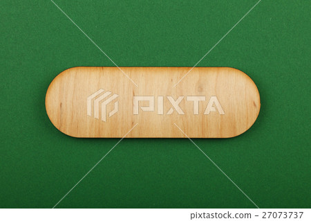 Figured shaped wooden sign on green background Figured shaped wooden sign on green background 27073737