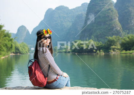 Girl admiring the karst scenic area outdoors Girl admiring the karst scenic area outdoors 27075287