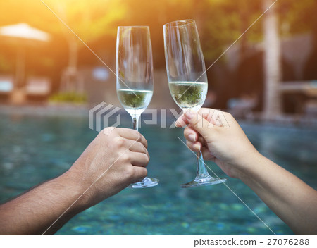 Couple holding glasses of champagne making a toast 27076288