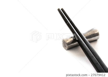 Black wooden chopsticks on metal chopstick rest Black wooden chopsticks on metal chopstick rest 27079412