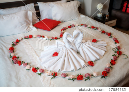Two swans made of towels forming heart shape on Two swans made of towels forming heart shape on 27084585