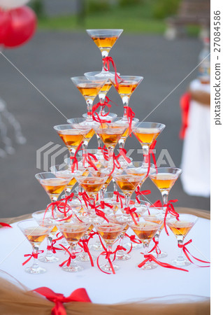 Pyramid of holiday wineglasses with wine or 27084586