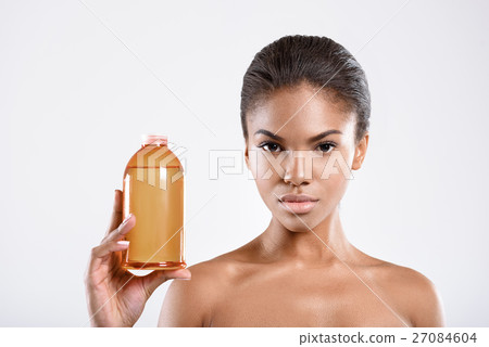 Young calm girl is holding a bottle 27084604