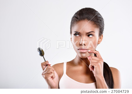 Serious young woman is thinking Serious young woman is thinking 27084729