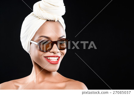 Smiling woman is wearing sunglasses Smiling woman is wearing sunglasses 27085037
