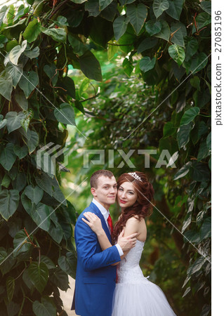 Wedding. Happy bride and groom together in garden Wedding. Happy bride and groom together in garden 27085196
