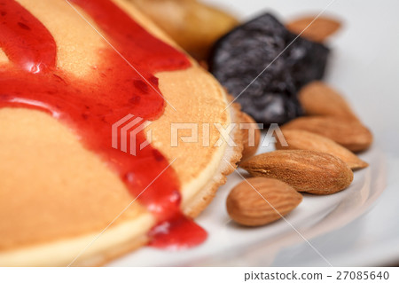 Delicious pancakes with red sweet strawberry syrup 27085640
