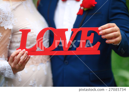 Love text in hands of bride and groom, wedding 27085734