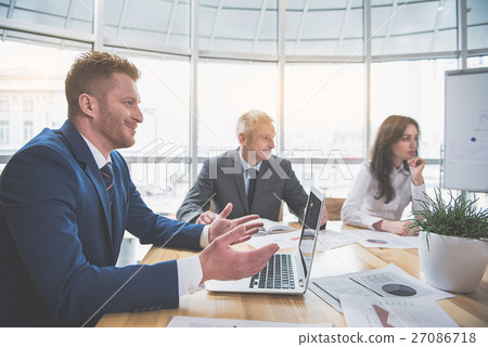 Happy man is sitting at office Happy man is sitting at office 27086718