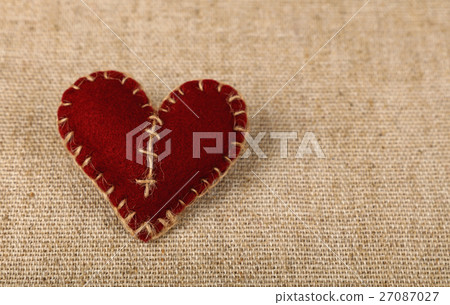 Brown felt craft heart over canvas close up Brown felt craft heart over canvas close up 27087027