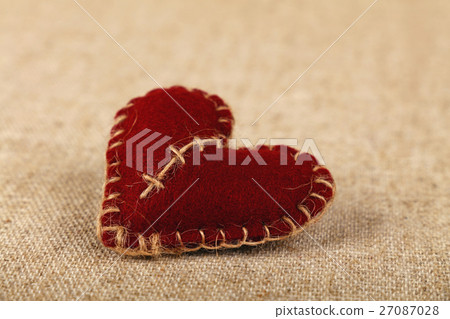 Brown felt craft heart over canvas close up Brown felt craft heart over canvas close up 27087028