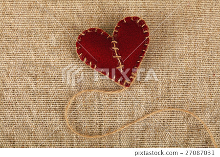Brown felt craft heart over canvas close up Brown felt craft heart over canvas close up 27087031